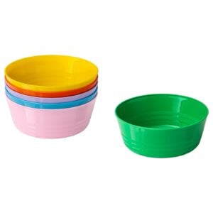 Stack of colorful plastic bowls stacked on the left (pink base, yellow top) next to a single green bowl on the right.